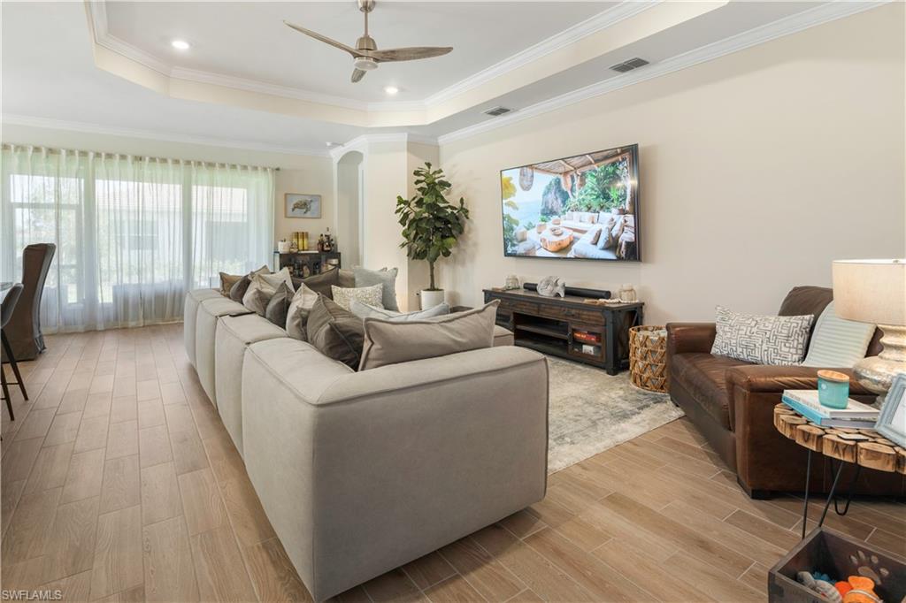 329 Deauville Loop Naples, FL 34114 - Photo 5 of 22 a living room with furniture and a flat screen tv