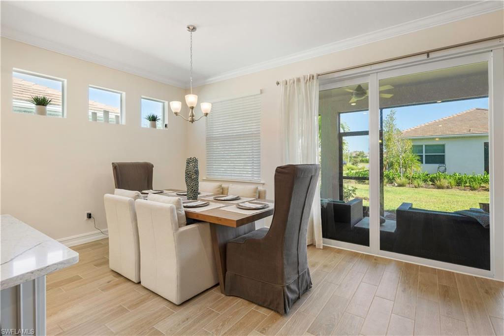 329 Deauville Loop Naples, FL 34114 - Photo 8 of 22 a view of a dining room with furniture window and wooden floor
