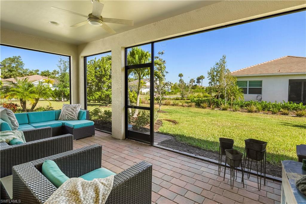 329 Deauville Loop Naples, FL 34114 - Photo 9 of 22 a living room with furniture and a large window