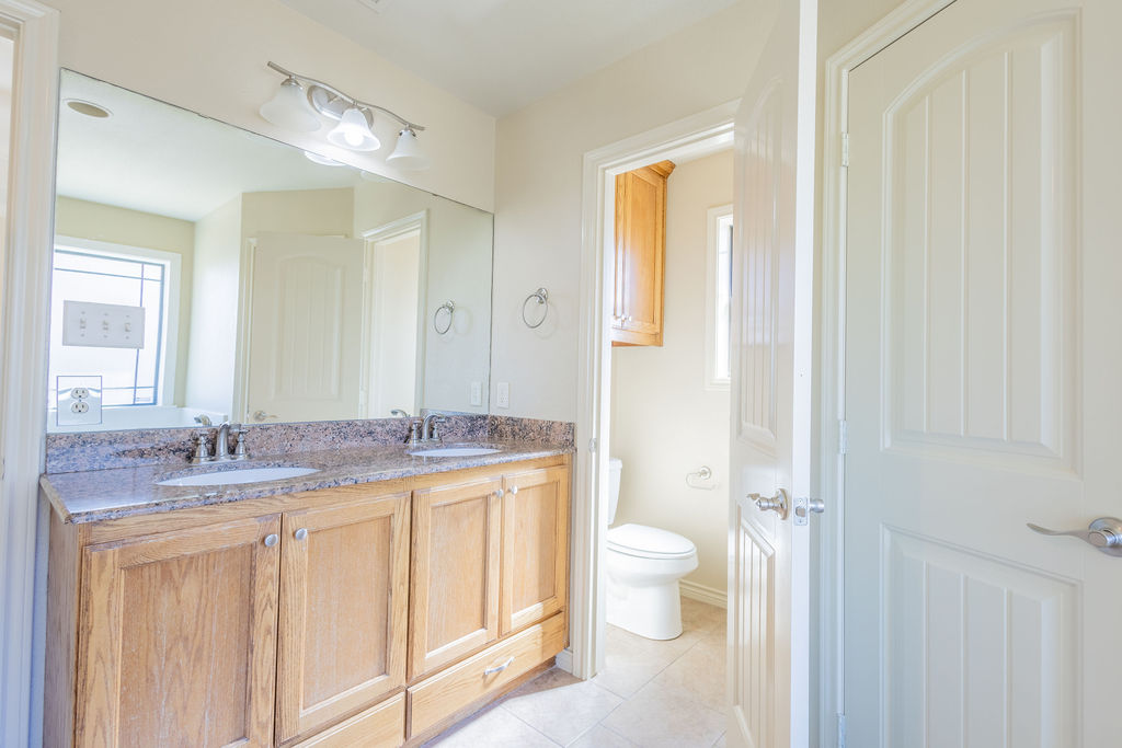 3309 Keefer Loop College Station, TX 77845 - Photo 11 of 27 a bathroom with a granite countertop sink toilet and shower