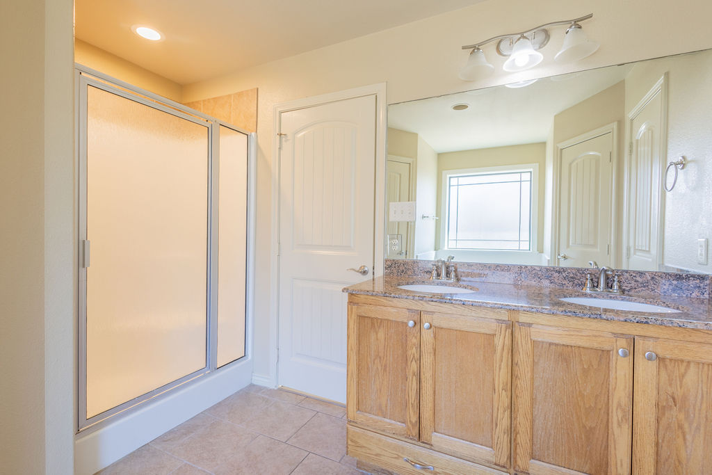 3309 Keefer Loop College Station, TX 77845 - Photo 12 of 27 a bathroom with a granite countertop sink and a mirror