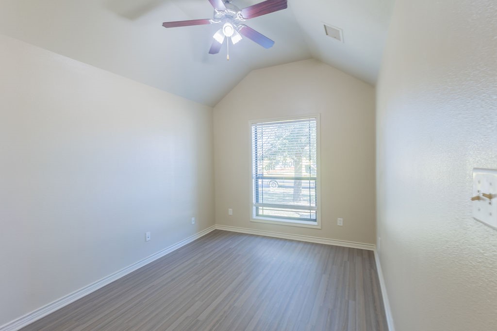 3309 Keefer Loop College Station, TX 77845 - Photo 14 of 27 an empty room with wooden floor fan and windows