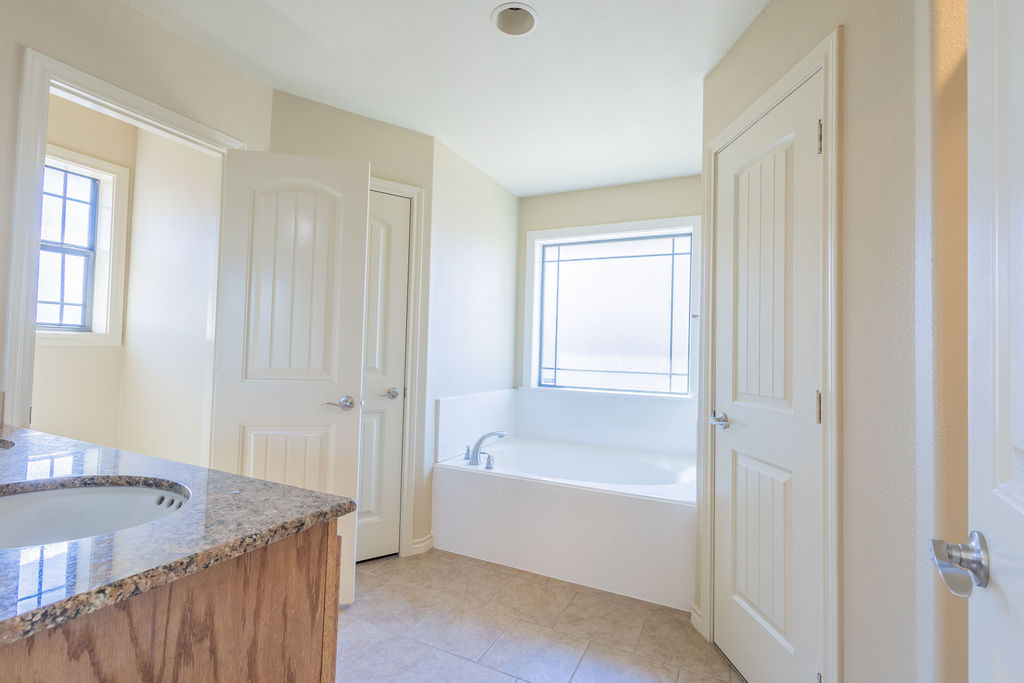 3309 Keefer Loop College Station, TX 77845 - Photo 10 of 27 a bathroom with a tub shower and a sink