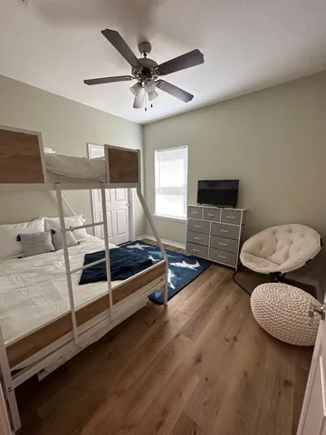 a bedroom with furniture and wooden floor