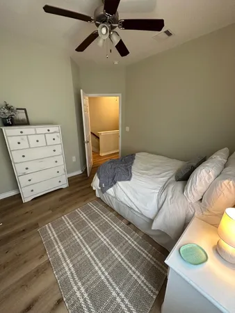 a bedroom with a bed and wooden floor
