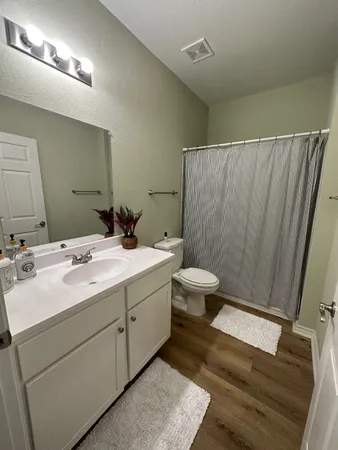 a bathroom with a double vanity sink and a mirror