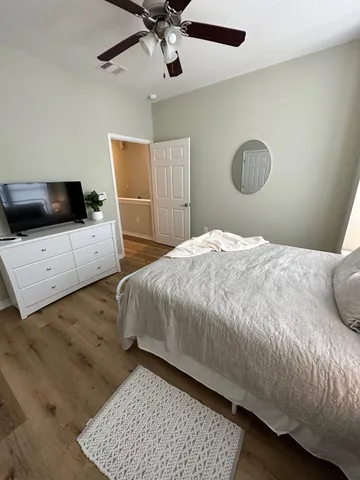 a bedroom with a large bed and a large window