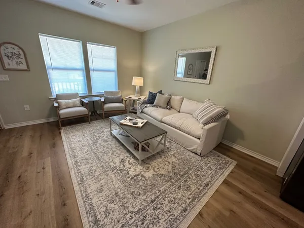 a living room with furniture and a rug