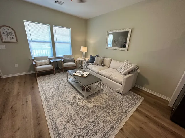 a living room with furniture and a rug