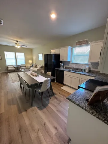 a large kitchen with a table and chairs in it