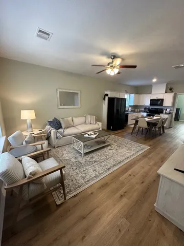 a living room with furniture a couch and a chandelier