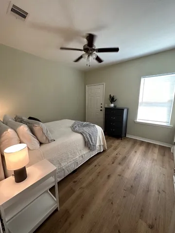 a bedroom with a bed and window