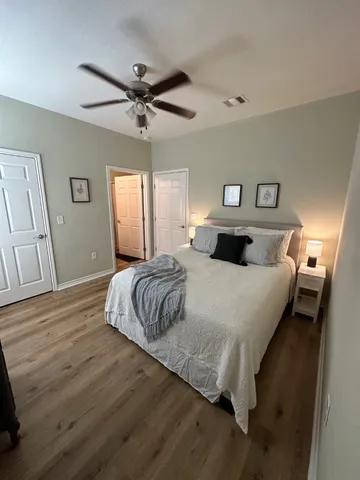 a bedroom with a bed and wooden floor
