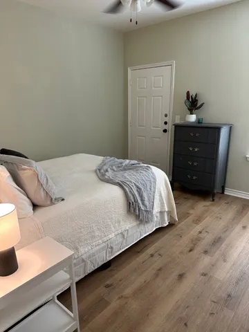 a bedroom with a bed and a dresser