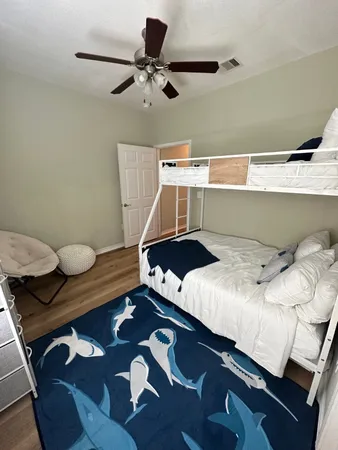 a bed sitting in a bedroom next to a window