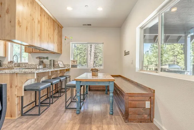 a dining room with wooden floor and a window