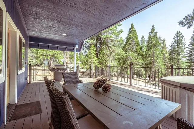 a view of a patio with table and chairs and wooden floor