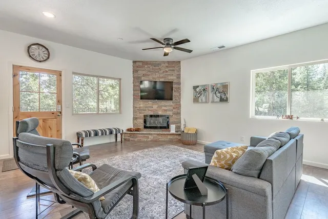 a living room with furniture a fireplace and a flat screen tv