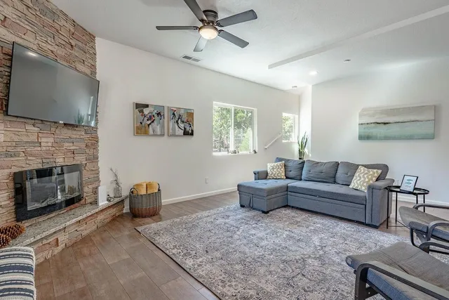 a living room with furniture and a fireplace