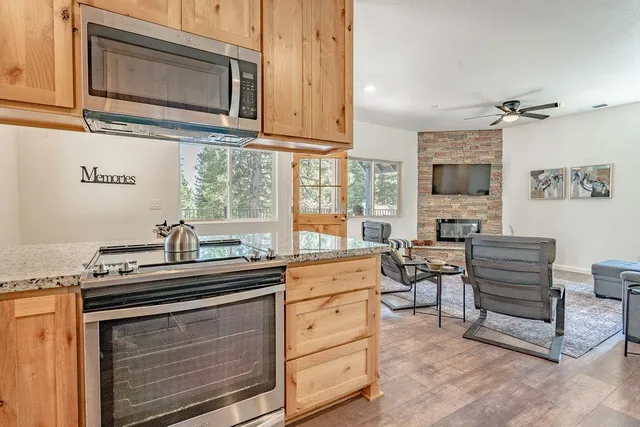 a kitchen with stainless steel appliances a stove microwave and cabinets