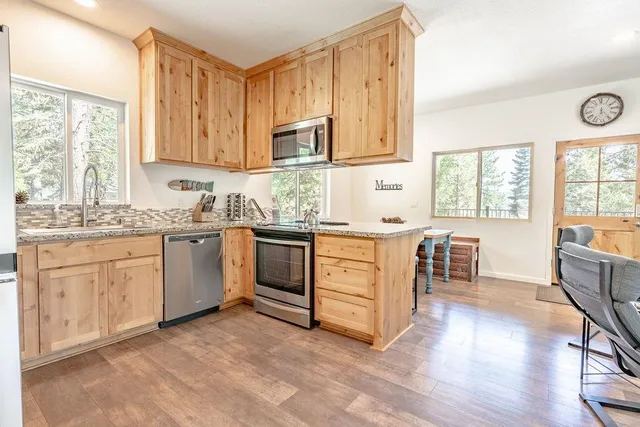 a kitchen with a sink stove and cabinets