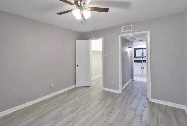 a view of an empty room with wooden floor