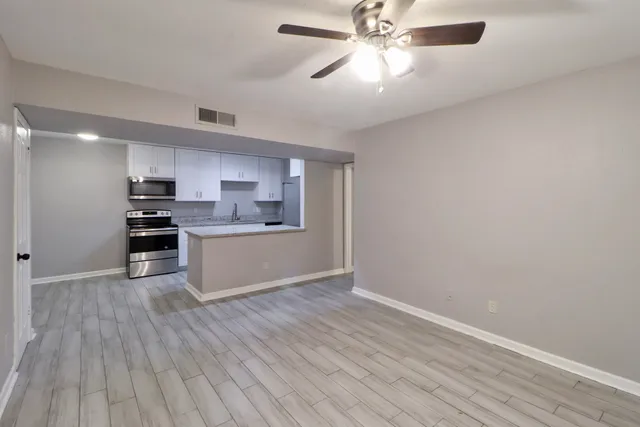 a view of kitchen with sink and wooden floor