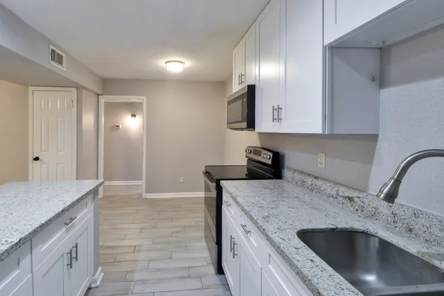 a kitchen with a sink and a refrigerator