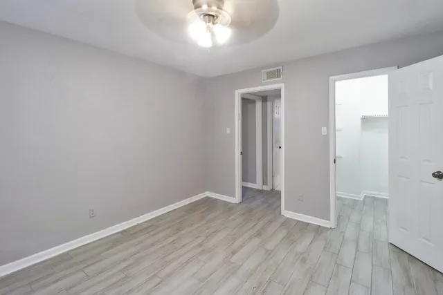 a view of an empty room with wooden floor