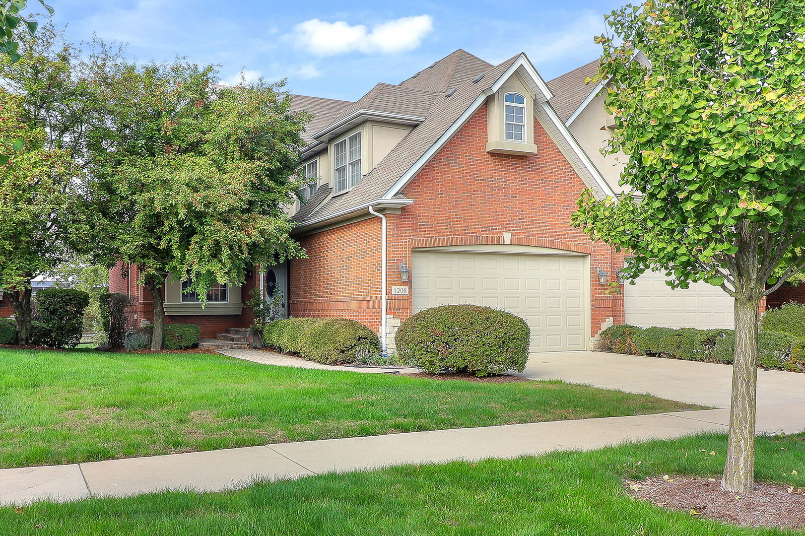 1208 Connamara Court Westmont, IL 60559 - Photo 1 of 36 a front view of a house with a yard and garage