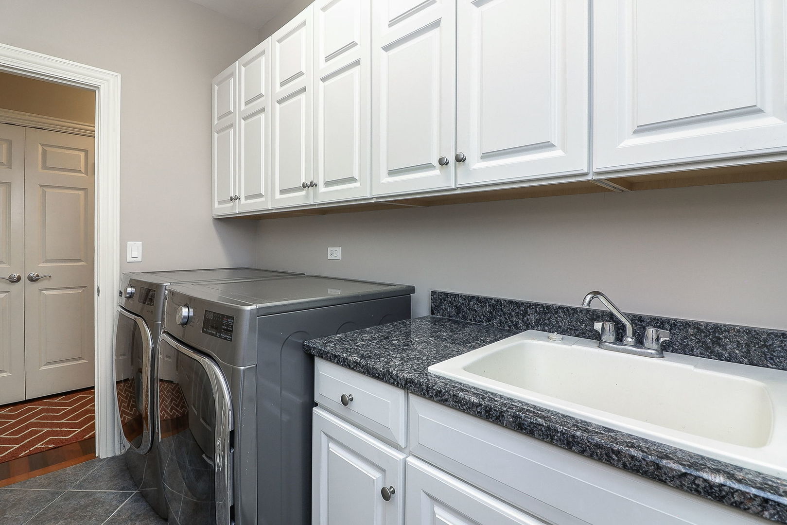 1208 Connamara Court Westmont, IL 60559 - Photo 16 of 36 a bathroom with granite countertop white cabinets and a sink