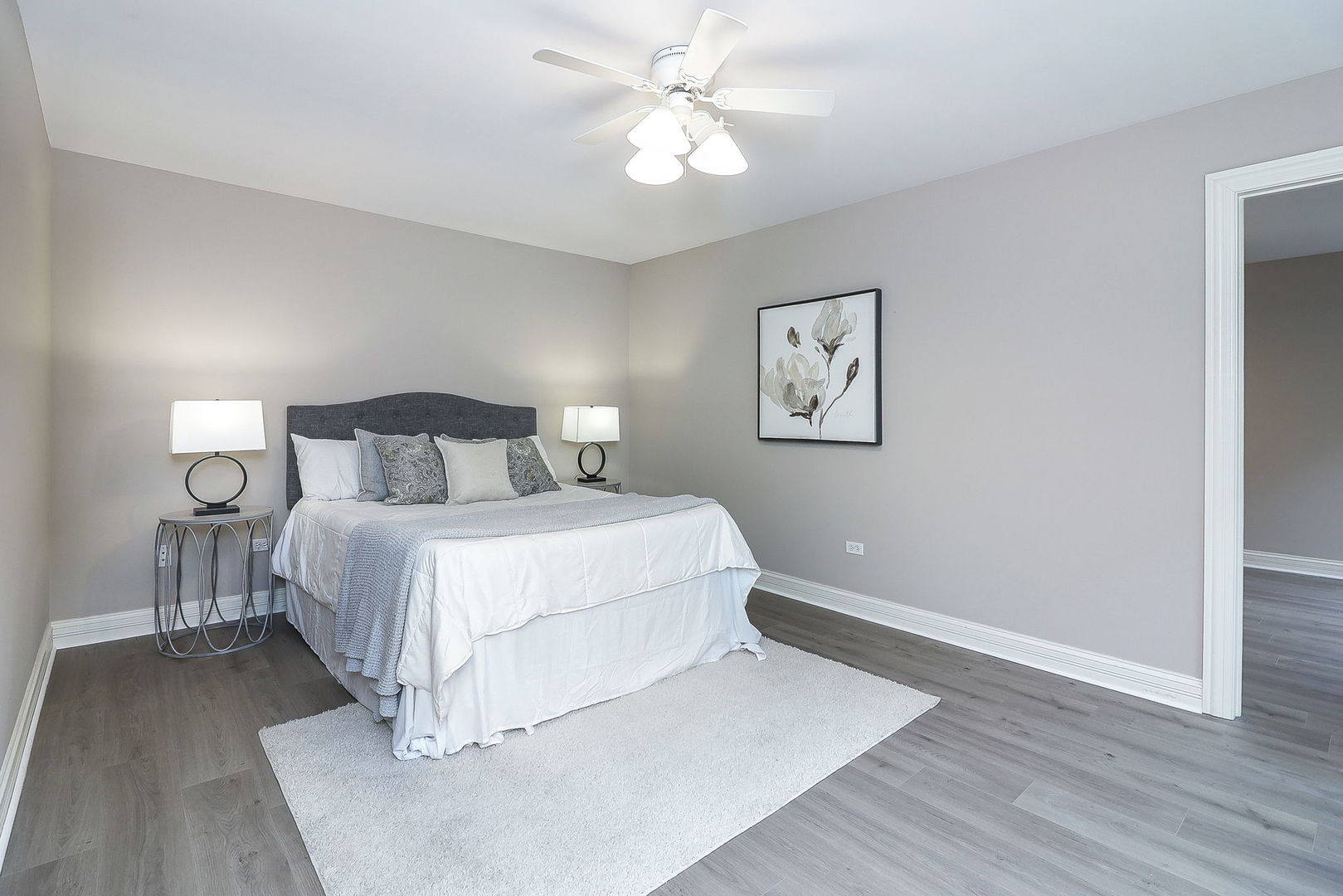 1208 Connamara Court Westmont, IL 60559 - Photo 20 of 36 a bedroom with a large bed and a chandelier