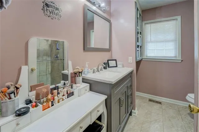 a bathroom with a sink mirror and vanity