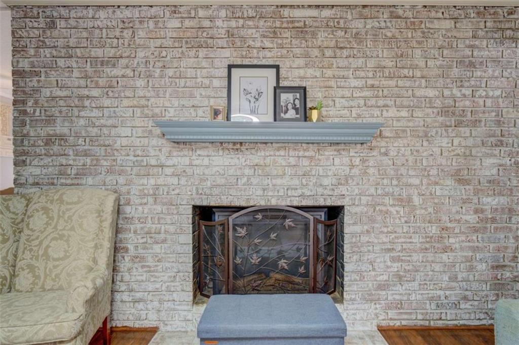 11889 Brown Bridge Road Covington, GA 30016 - Photo 3 of 18 a room with a bench and a fireplace