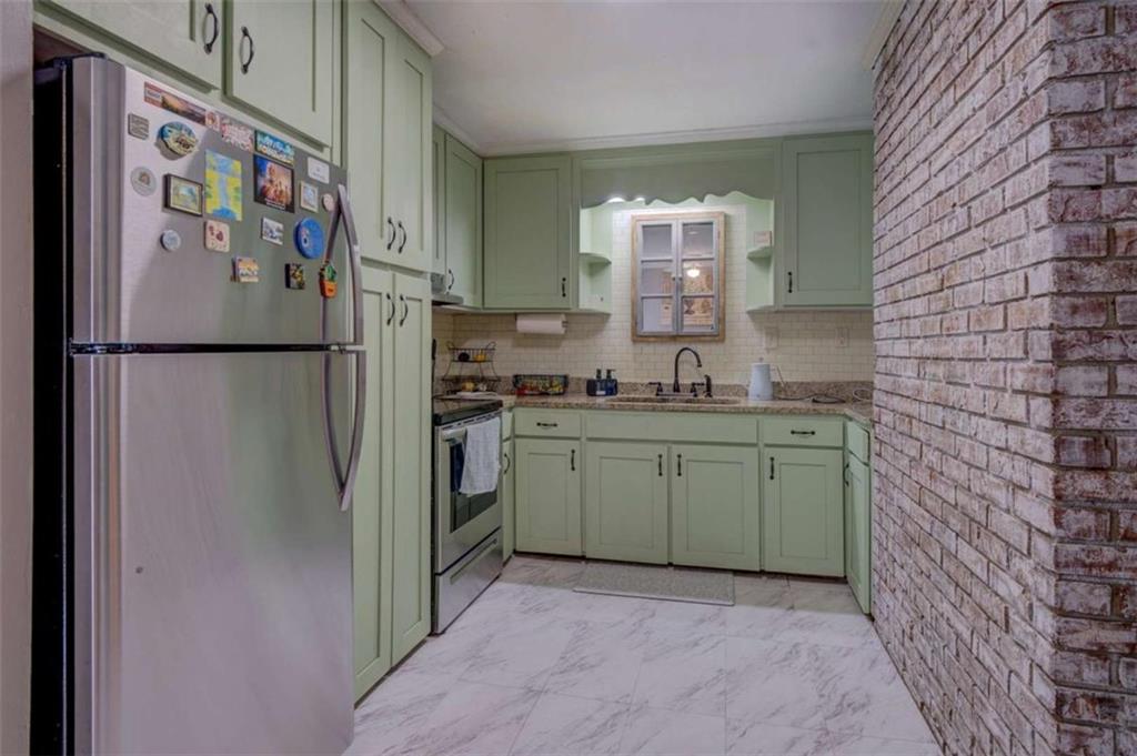11889 Brown Bridge Road Covington, GA 30016 - Photo 5 of 18 a kitchen with a refrigerator and a sink
