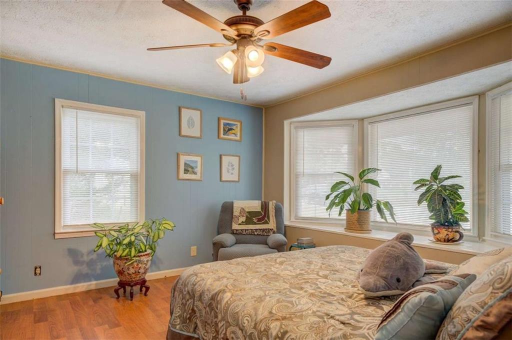 11889 Brown Bridge Road Covington, GA 30016 - Photo 7 of 18 a bedroom with a bed and a chandelier