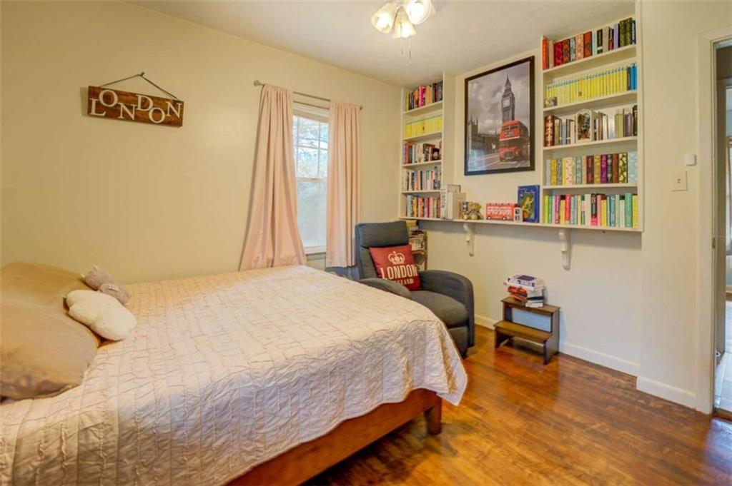 11889 Brown Bridge Road Covington, GA 30016 - Photo 10 of 18 a bedroom with a bed and a book shelf