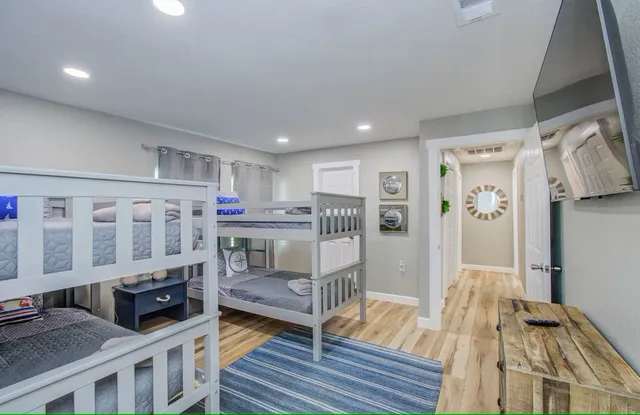 a living room with stainless steel appliances furniture and a kitchen view
