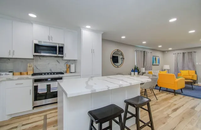 a large kitchen with a table and chairs