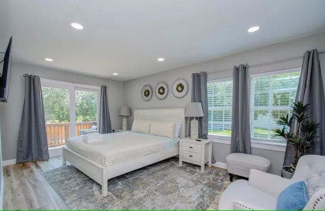 a bedroom with a bed and a large window