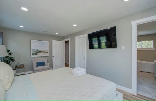 a bedroom with a bed and a flat screen tv