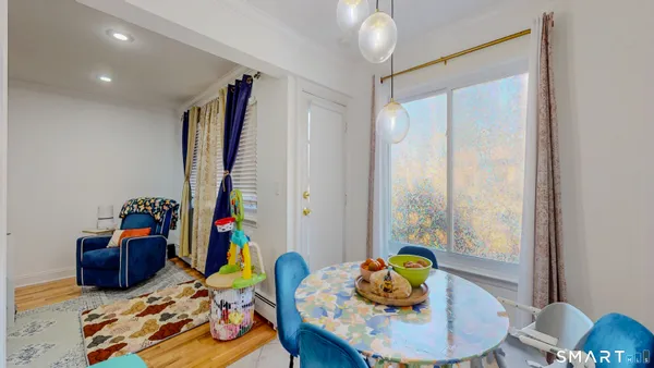 a living room with furniture and book shelf