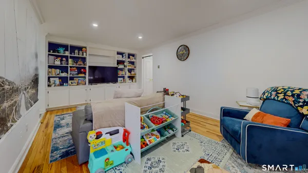 a living room with furniture and wooden floor