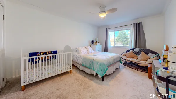 a bedroom with a bed and window