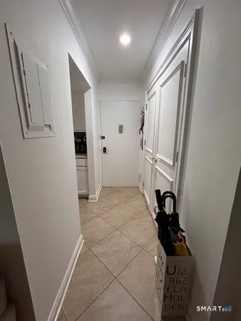a balcony with wooden floor and outdoor seating