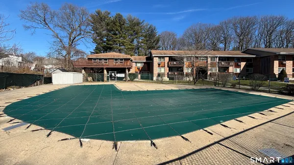 a view of a yard with large trees