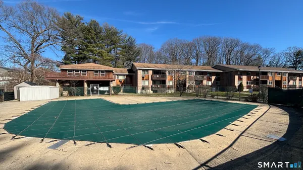 a picture of a bench in front of a wall