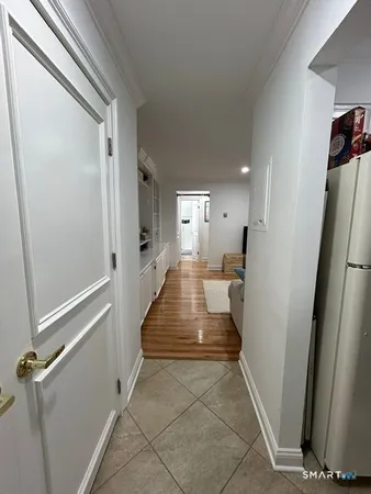 a kitchen with stainless steel appliances kitchen island granite countertop a table chairs and a refrigerator