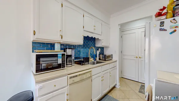 a kitchen with refrigerator and cabinets