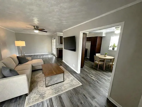 a living room with furniture and a rug